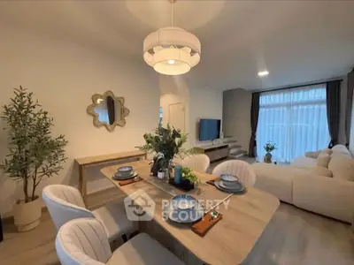 Elegant living room with modern dining area and cozy seating, perfect for entertaining.