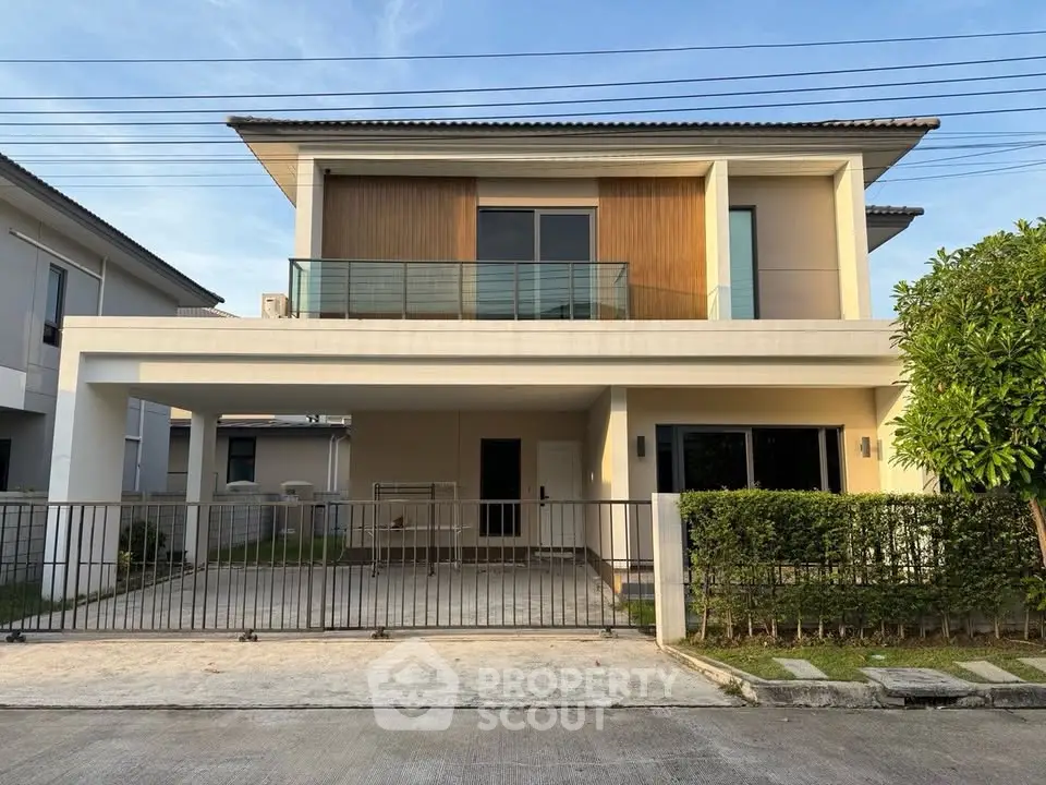 Modern two-story house with spacious driveway and contemporary design in a serene neighborhood.