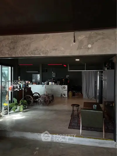 Industrial-style open living space with concrete floors and modern decor