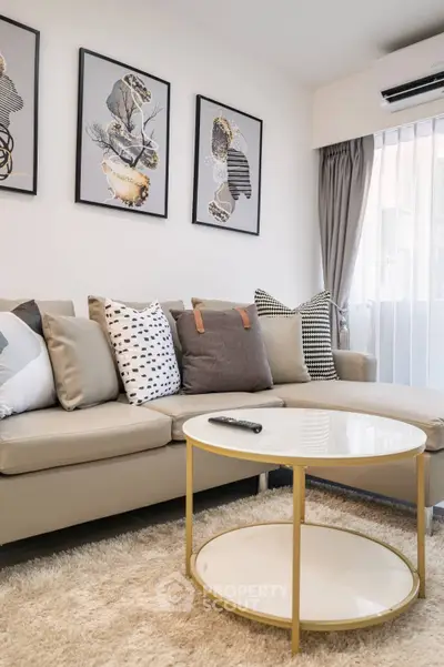 Chic modern living room with plush sofa set, stylish wall art, and elegant coffee table, perfect for urban living.