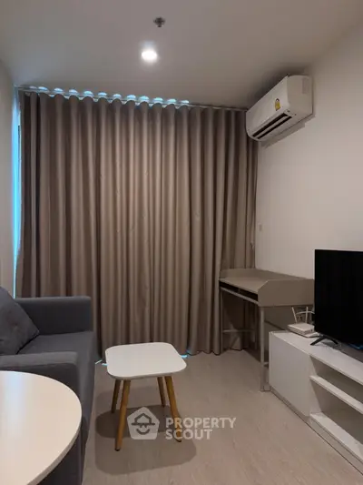 Modern living room with sleek furniture and air conditioning in a cozy apartment.