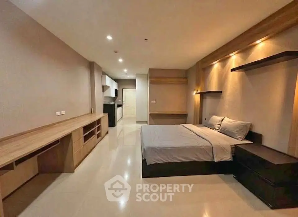 Spacious modern bedroom with sleek design and ample storage in a contemporary apartment.
