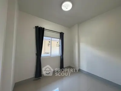 Bright empty room with window and curtains, ideal for customization.