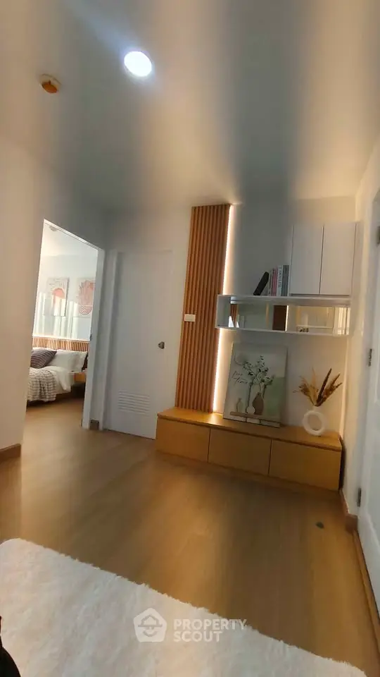 Modern interior with wooden flooring and stylish decor, featuring a cozy bedroom view.