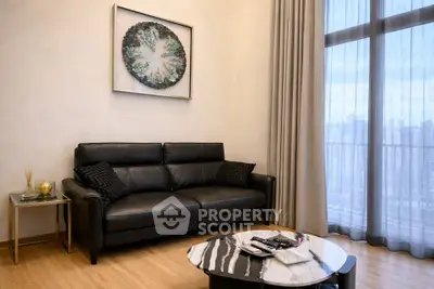 Elegant living room with black leather sofa and modern decor, featuring a large window with city view.