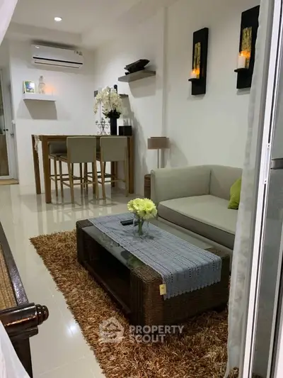 Chic living room with modern decor, cozy sofa, and elegant dining area, perfect for stylish urban living.