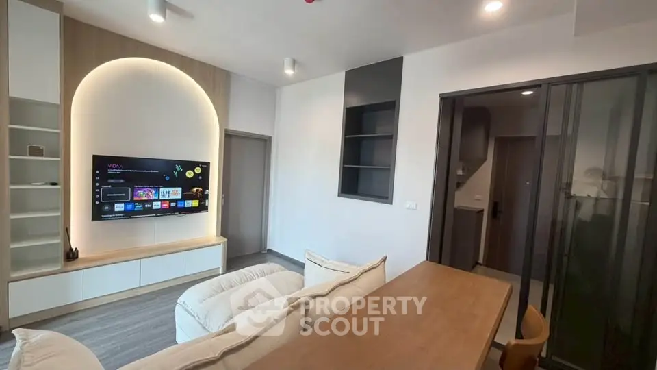 Modern living room with sleek TV setup and cozy seating area