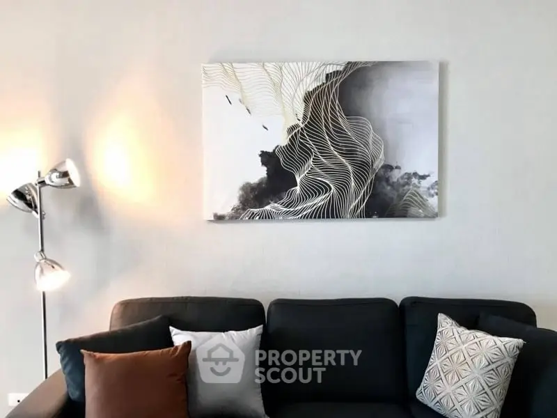 Modern living room with stylish sofa and abstract wall art, perfect for contemporary home decor.