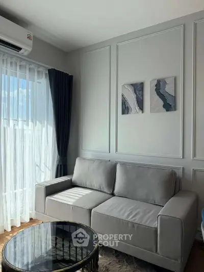 Chic modern living room with elegant gray sofa and stylish decor, perfect for urban living.