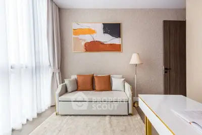 Modern living room with stylish sofa, abstract art, and natural light