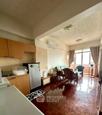 Charming living room with natural light, cozy seating, and modern appliances in an inviting open layout.