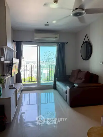 Modern living room with balcony view, featuring sleek furniture and natural light.