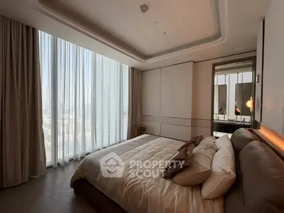 Luxurious bedroom with floor-to-ceiling windows and elegant decor