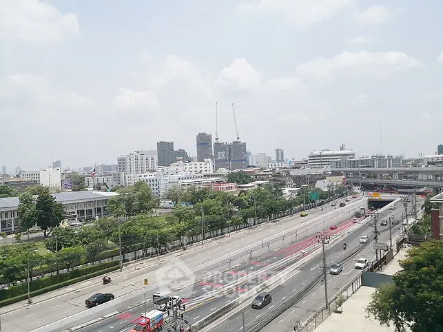 Cityscape view with roads and buildings under a clear sky