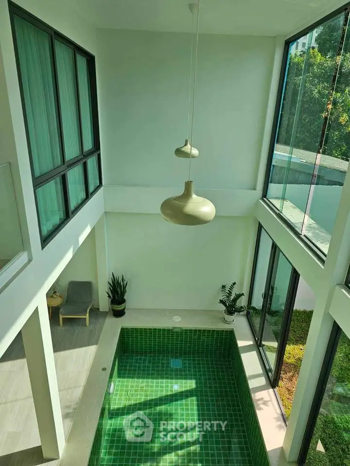 Luxurious indoor pool with modern design and large windows for natural light