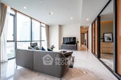 Luxurious modern living room with large windows and city view, featuring sleek furniture and elegant decor.
