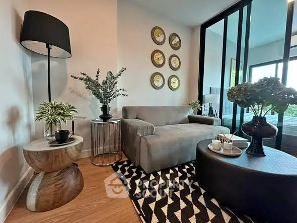 Stylish living room with modern decor and cozy seating area, perfect for relaxation.