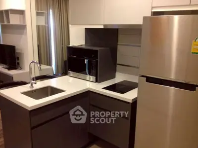 Modern kitchen with sleek appliances and compact design