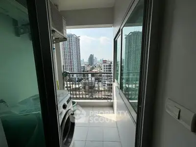 Modern apartment balcony with city view and laundry area, perfect for urban living.