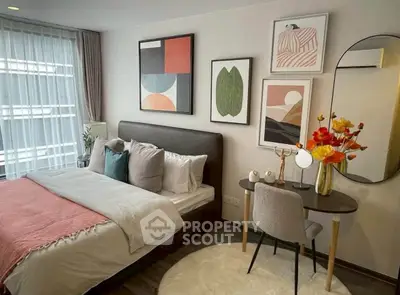 Stylish bedroom with modern decor and cozy ambiance, featuring a comfortable bed and elegant artwork.