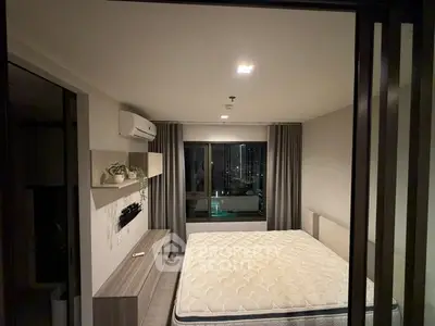 Modern bedroom with large window and minimalist decor in urban apartment
