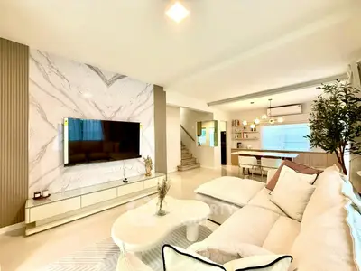 Luxurious open-plan living room with modern decor and stylish kitchen