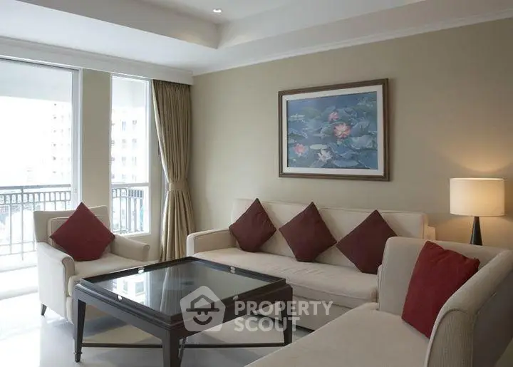 Elegant living room with modern furniture and large windows offering natural light and city views.