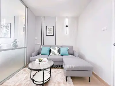 Modern living room with stylish gray sofa and chic decor