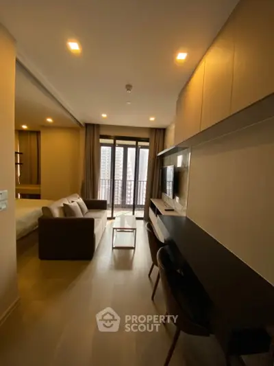 Modern living room with sleek furniture and large windows offering city views