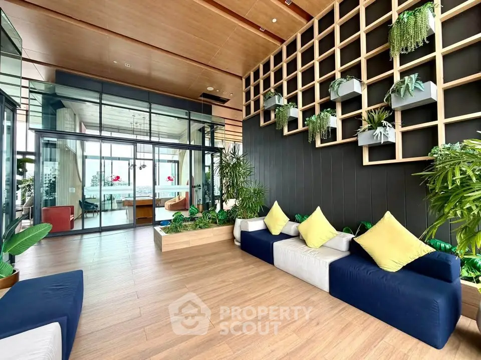 Luxurious modern living room with stylish decor and panoramic city view, featuring elegant wooden flooring and lush greenery.