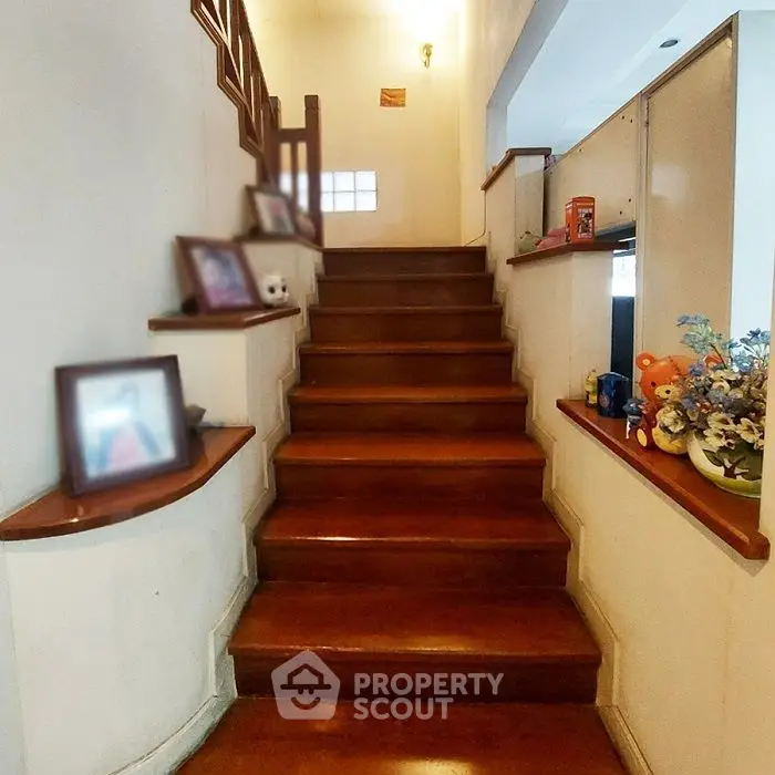 Elegant wooden staircase with decorative accents in a cozy home setting.