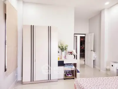 Bright and cozy bedroom with modern wardrobe and stylish decor
