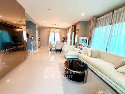 Luxurious open-plan living room with elegant decor and ample natural light