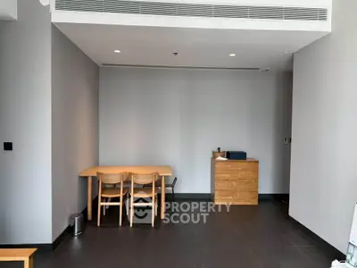 Spacious modern living room with minimalist furniture and sleek design.