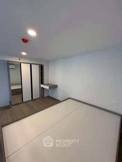 Modern minimalist bedroom with built-in wardrobe and sleek flooring