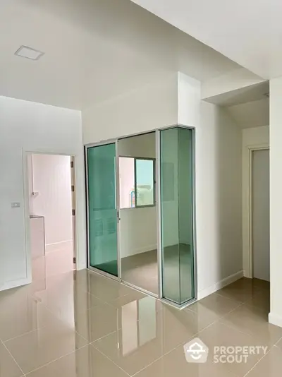 Modern interior with glass partition and glossy tiled floor