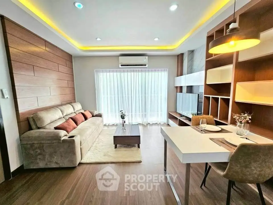 Modern living room with stylish decor, cozy sofa, and elegant lighting in a contemporary apartment.