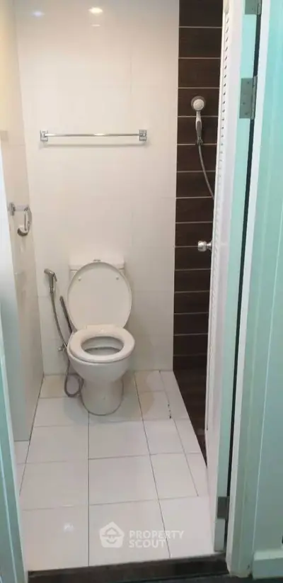 Compact bathroom with modern fixtures and white tile flooring