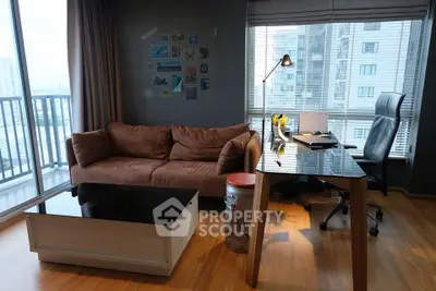 Modern living room with city view, stylish furniture, and ample natural light.