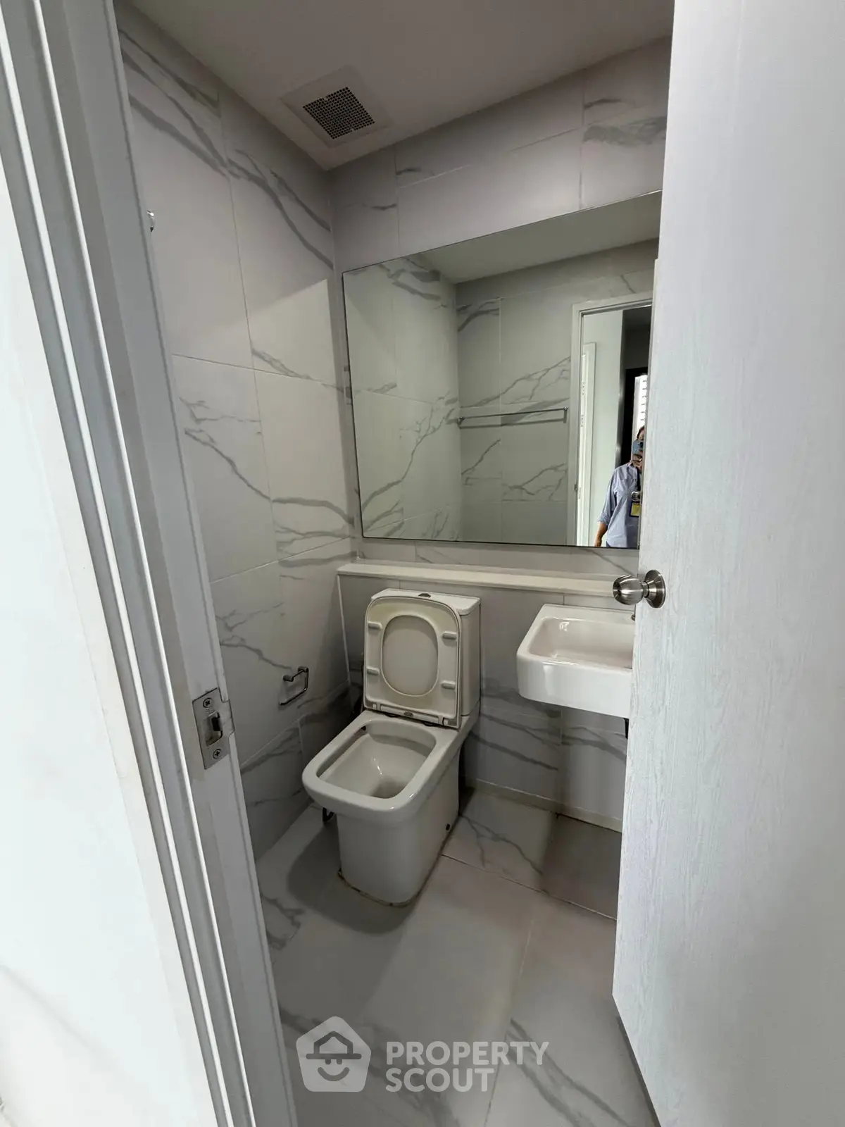 Modern bathroom with sleek marble tiles and compact design