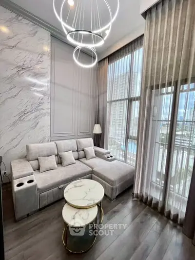 Luxurious modern living room with elegant marble accents and floor-to-ceiling windows.