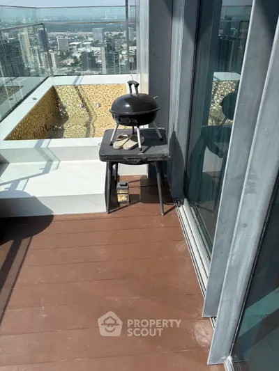 Luxurious high-rise balcony with BBQ grill and stunning city view