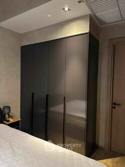 Modern bedroom with sleek wardrobe and cozy lighting