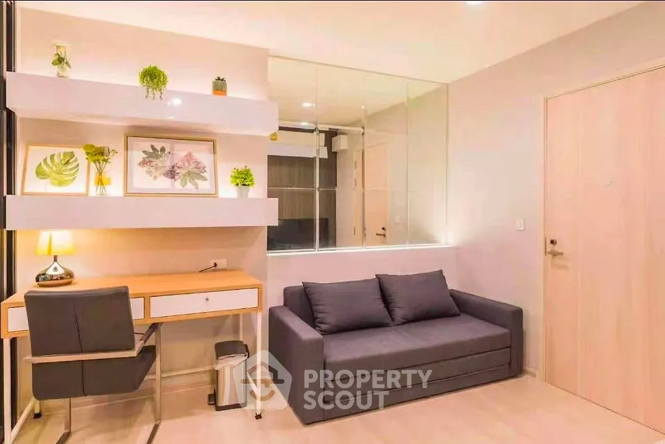 Modern living room with stylish decor and workspace, featuring a cozy sofa and elegant desk.