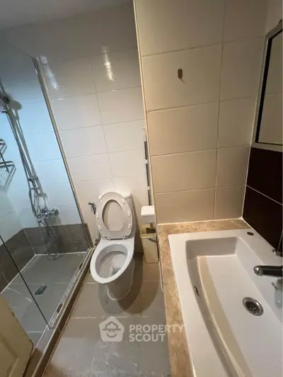 Modern bathroom with shower and sink in real estate property