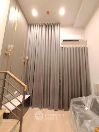 Modern interior with high ceilings and elegant curtains in a stylish living space.