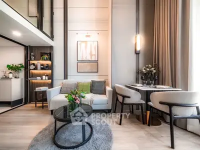 Modern living room with elegant decor, cozy seating, and stylish dining area in open-plan apartment.