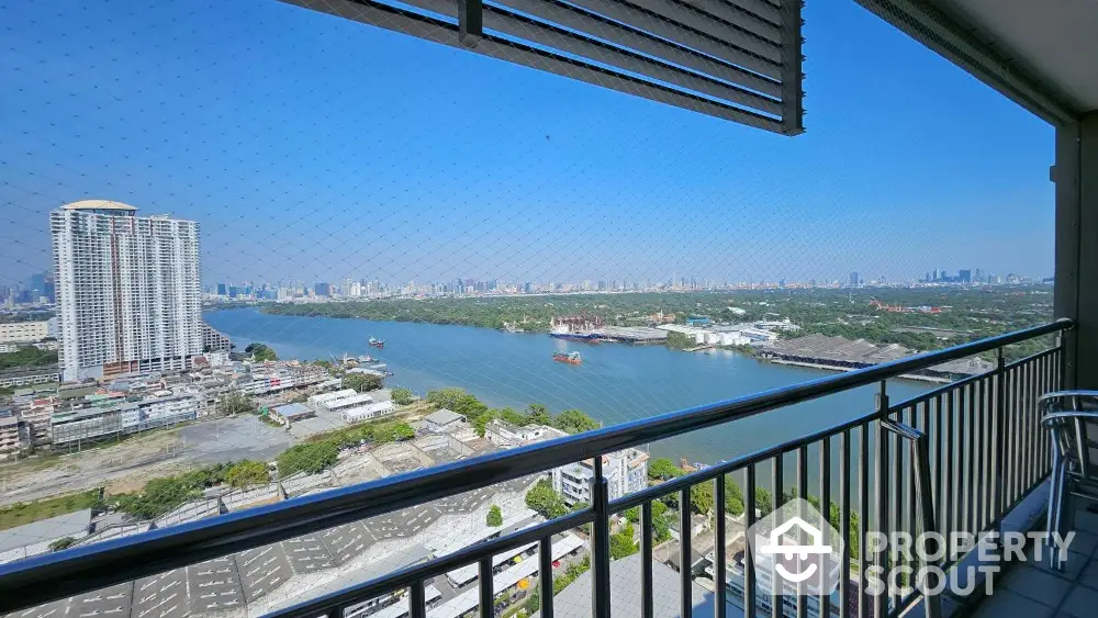 Stunning high-rise balcony view overlooking river and city skyline