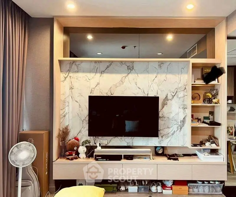 Modern living room with stylish TV unit and marble accent wall