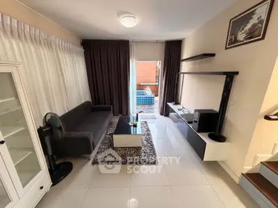 Modern living room with sleek furniture and pool view